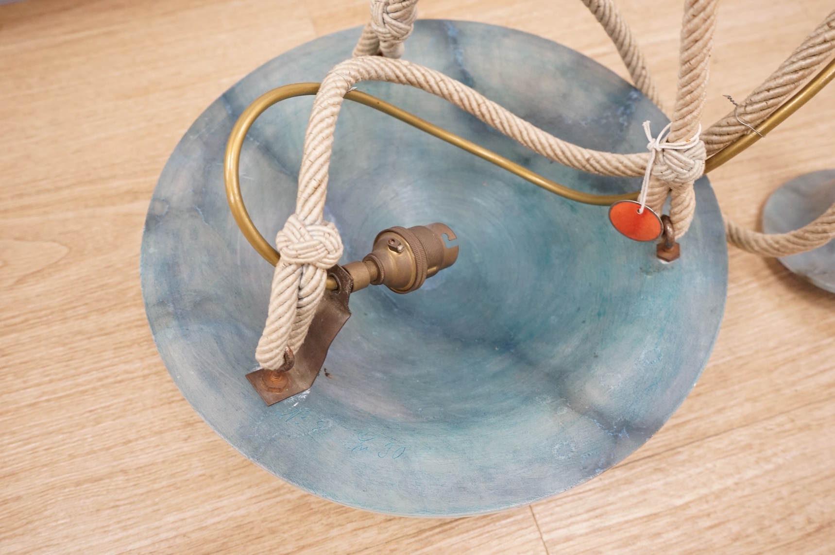 A French Art Deco blue alabaster plafonnier and matching ceiling rose, with cream cord, inscribed number, 30cm diameter